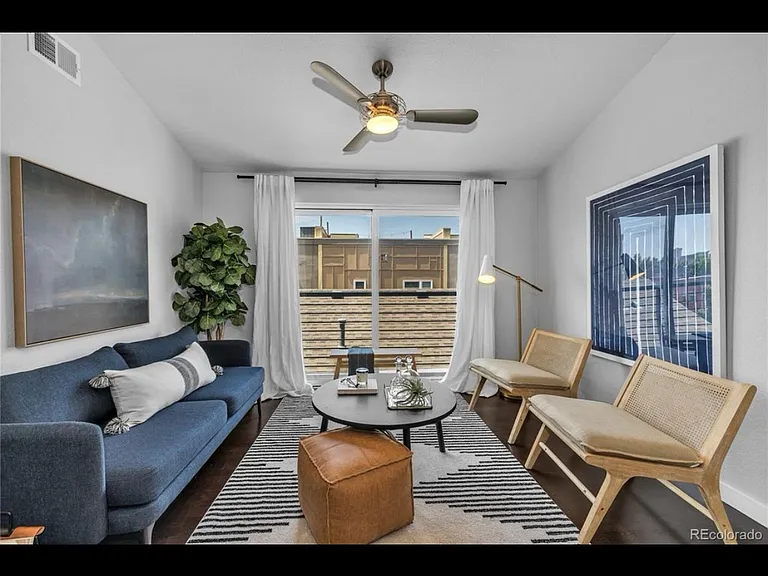 Warm living room with sofa on the left and two chairs on the right